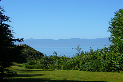 View of private beach and mountains from lower level patio