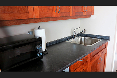 Each unit features a kitchenette with microwave, fridge, sink, coffee maker, kettle, dishes and utensils